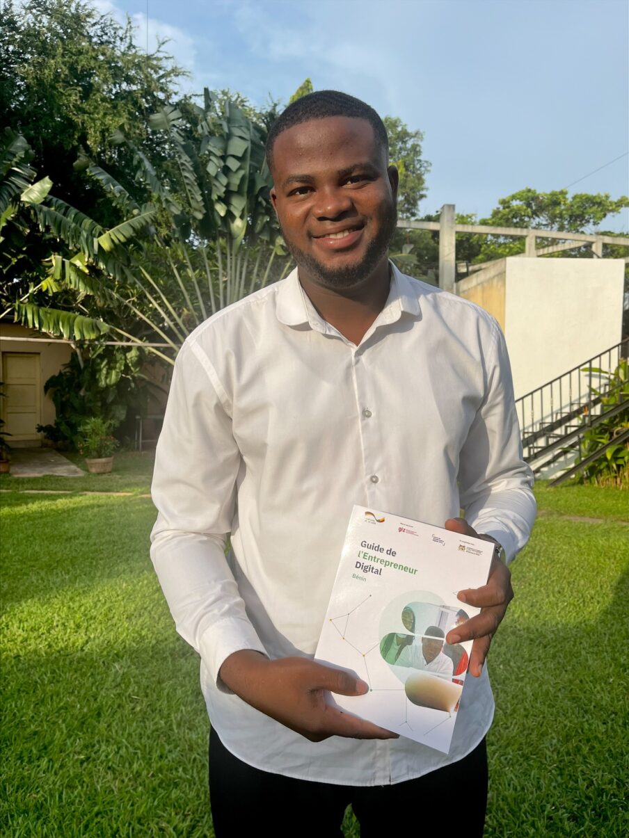 Young man holding a booklet