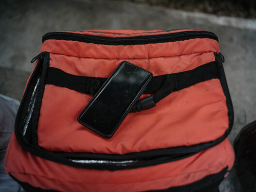 Phone on red bag.