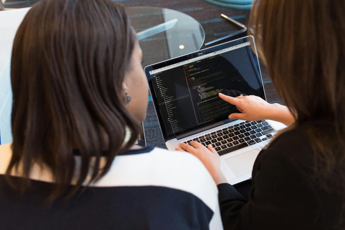 Two women coding.